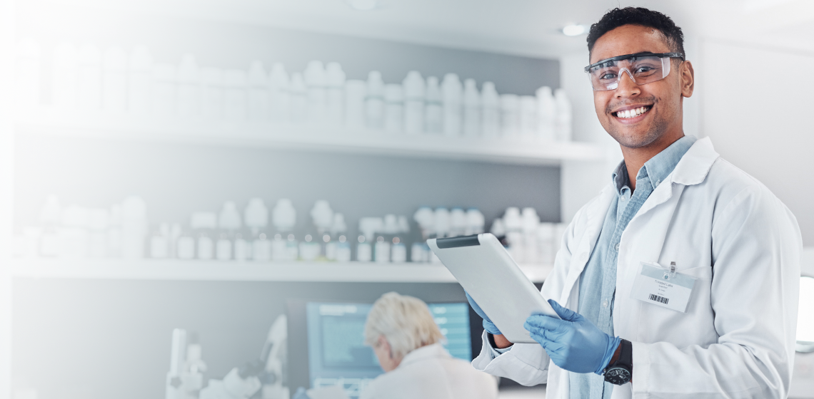 Male scientist in lab holding clipboard